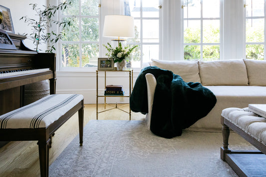 Warm winter living room with layered textiles and warm lamplight —  winter home guide — A Design Lifestyle